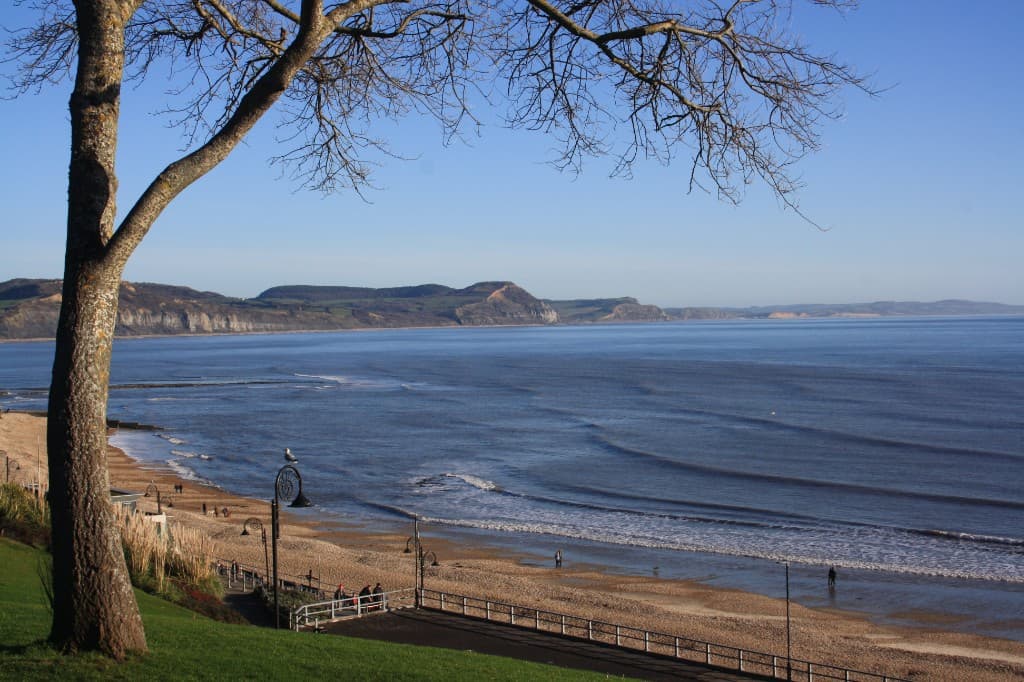 Sunny Dorset coastline with beach, sea and cliffs